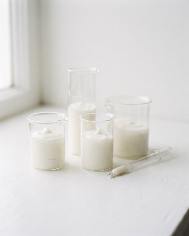 Glass beakers with cosmetic emulsions in a laboratory