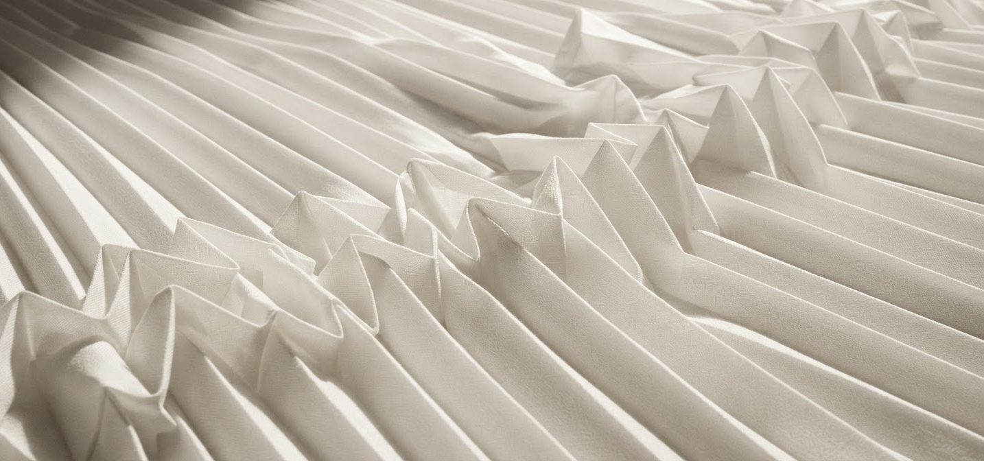 White fabric folded into precise pleats